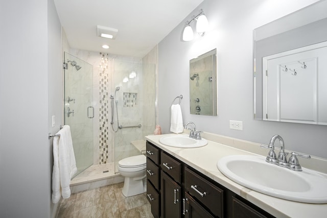 full bath with double vanity, a stall shower, toilet, and a sink