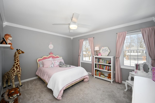 carpeted bedroom with a ceiling fan, crown molding, and baseboards