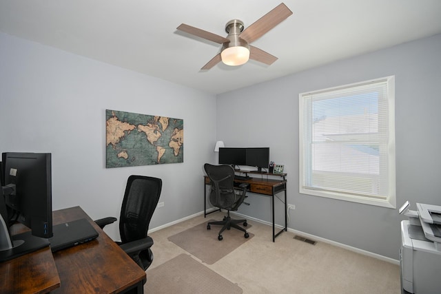 home office with a ceiling fan, visible vents, baseboards, and carpet floors