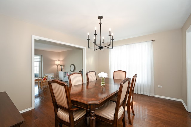 dining area with a notable chandelier, baseboards, and wood finished floors