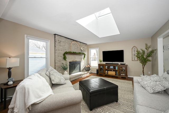 living room with a wealth of natural light, a brick fireplace, and a skylight