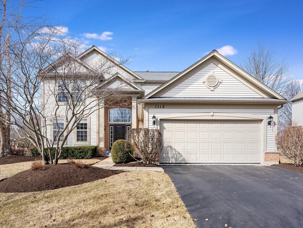 1112 Glen Eagle Dr, Aurora, IL 60502 - view of front of house featuring aphalt driveway, brick siding, and a garage