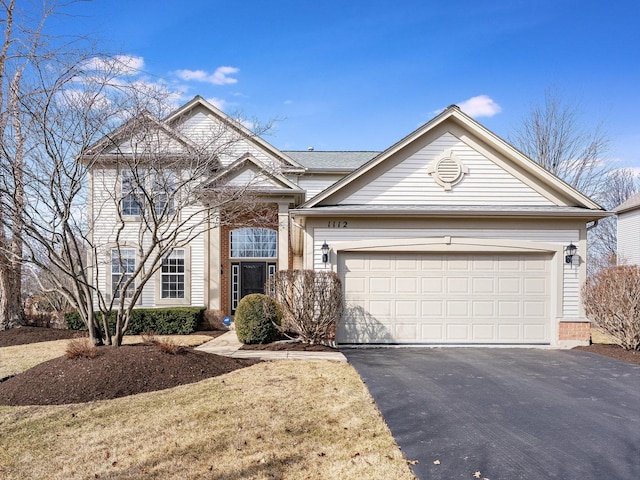 view of front of house featuring aphalt driveway, brick siding, and a garage