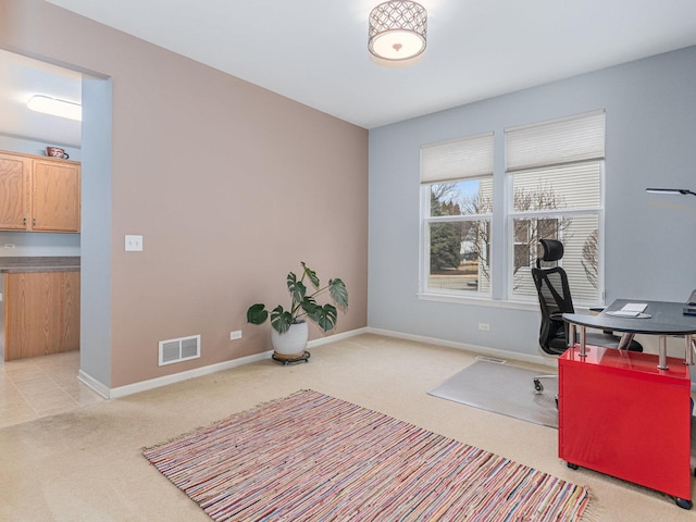 office space featuring visible vents, light colored carpet, and baseboards