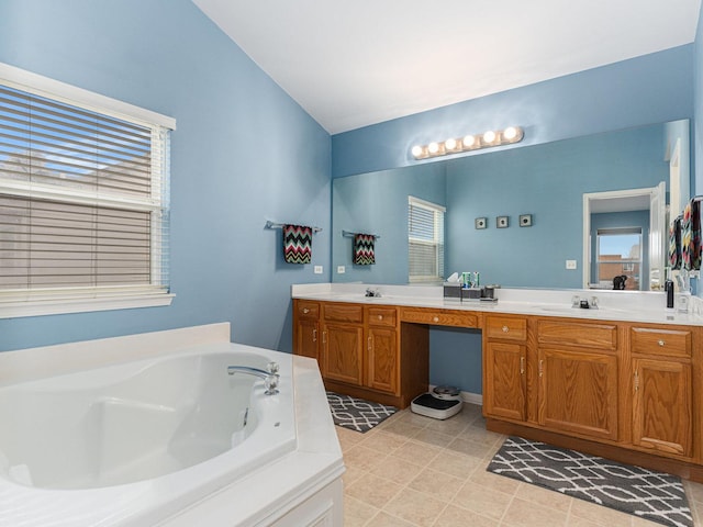 bathroom with double vanity, a bath, and a sink