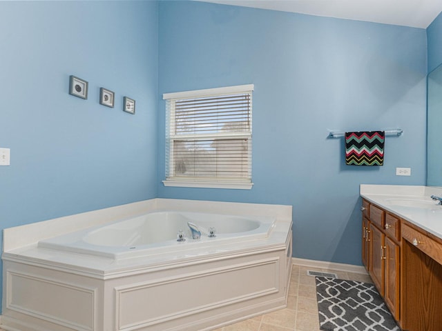 bathroom with vanity, visible vents, baseboards, tile patterned flooring, and a bath