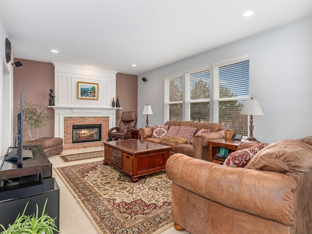 living area featuring recessed lighting and a brick fireplace