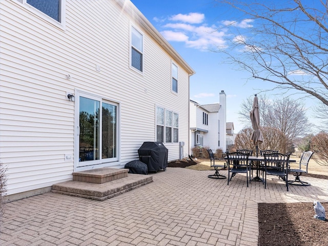 view of patio featuring outdoor dining area and a grill