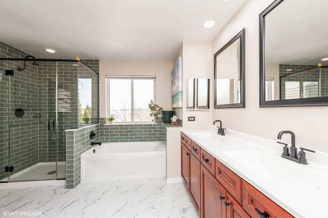 full bath with a bath, marble finish floor, a shower stall, and a sink