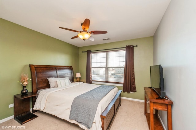 bedroom featuring visible vents, light colored carpet, baseboards, and ceiling fan