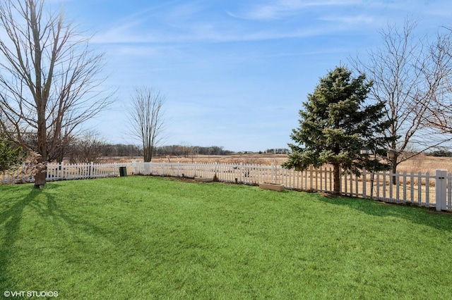 view of yard featuring a rural view and fence