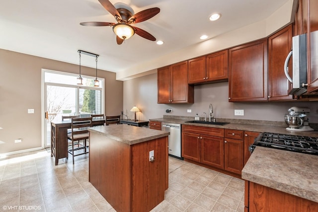 kitchen featuring a ceiling fan, a kitchen island, recessed lighting, a sink, and appliances with stainless steel finishes