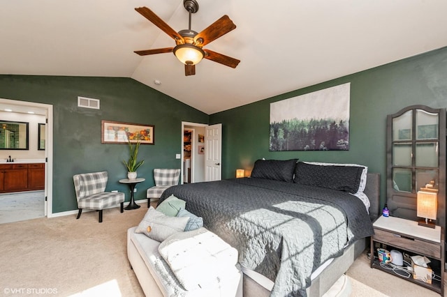 carpeted bedroom featuring visible vents, connected bathroom, baseboards, ceiling fan, and vaulted ceiling