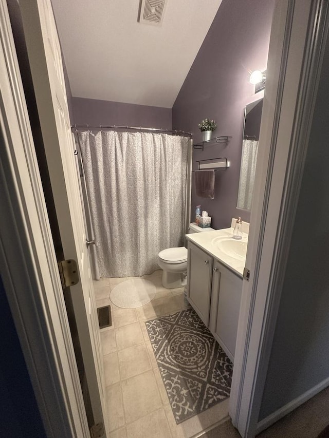 full bath with visible vents, toilet, vaulted ceiling, tile patterned floors, and vanity