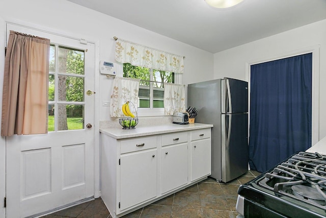 1405 Newcastle Ln, Hoffman Estates, IL 60169 - kitchen featuring freestanding refrigerator, light countertops, black gas range oven, and healthy amount of natural light