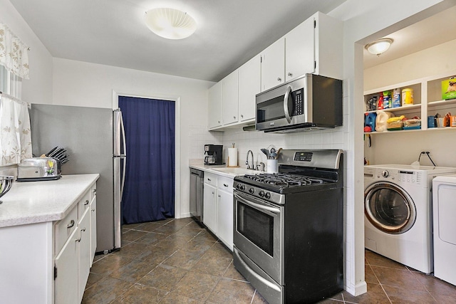1405 Newcastle Ln, Hoffman Estates, IL 60169 - kitchen with stainless steel appliances, separate washer and dryer, decorative backsplash, light countertops, and white cabinetry