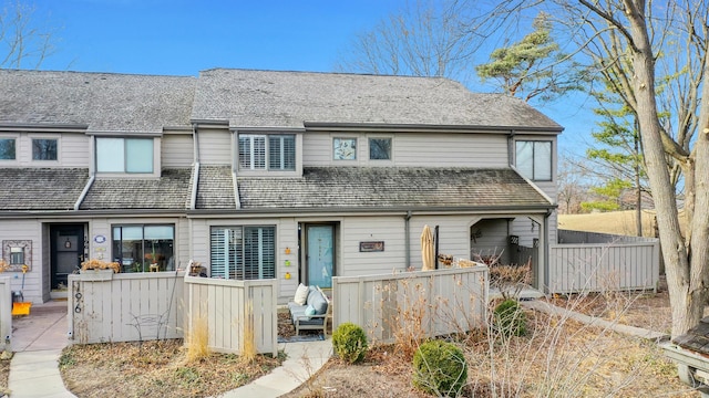 rear view of house featuring fence