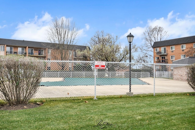 view of swimming pool with a yard and fence