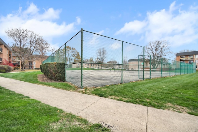 view of sport court featuring a lawn and fence