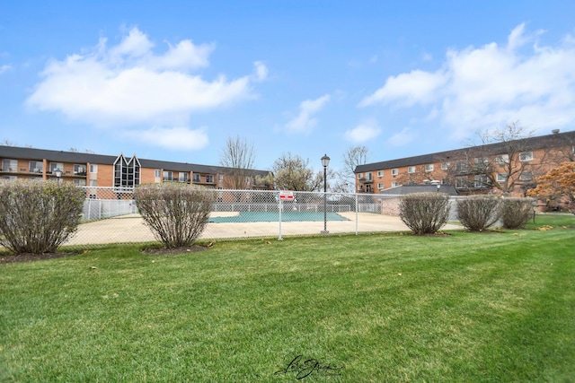 view of pool featuring community basketball court, a yard, and fence