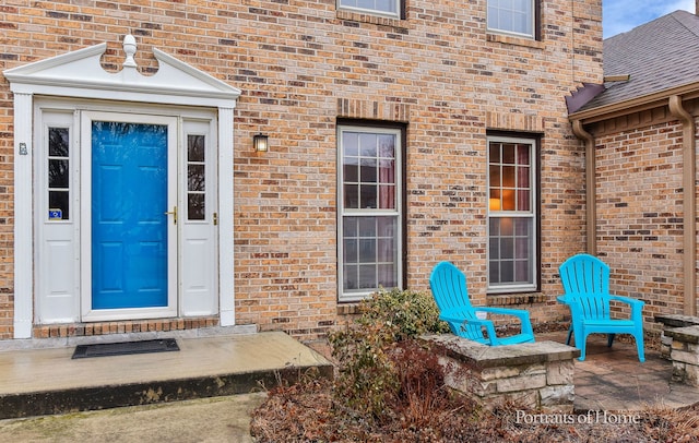 property entrance featuring brick siding