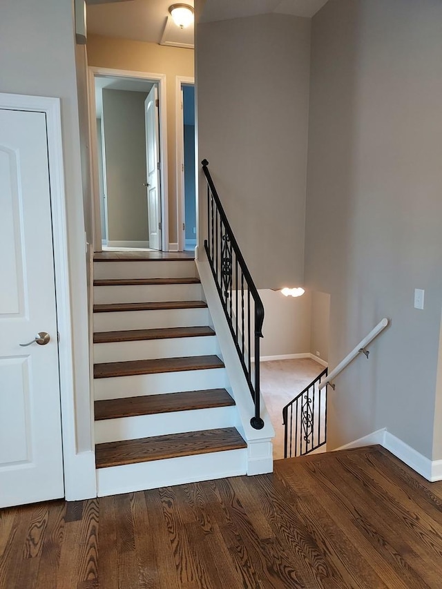 stairway with baseboards and wood finished floors