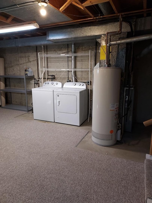 unfinished basement with gas water heater and washing machine and clothes dryer