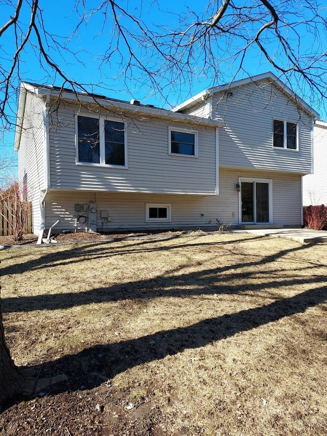 rear view of property with a yard