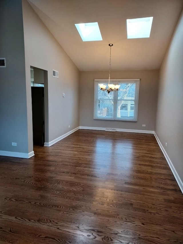 unfurnished dining area with dark wood-style floors, visible vents, and baseboards