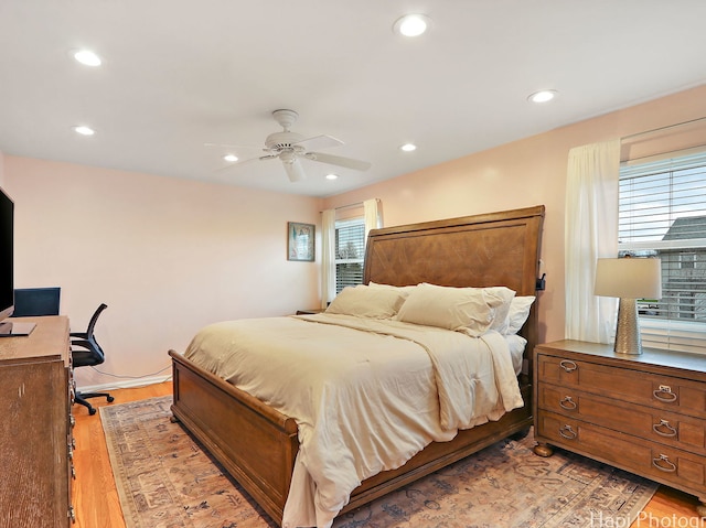 bedroom with light wood-type flooring, recessed lighting, a ceiling fan, and an office area