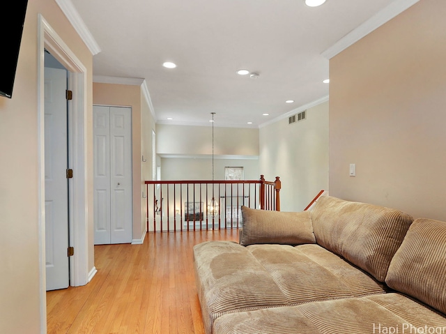 hallway featuring ornamental molding, light wood-style floors, recessed lighting, and baseboards
