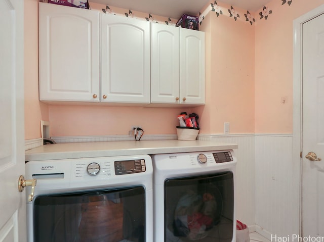 laundry area featuring independent washer and dryer, wainscoting, and cabinet space