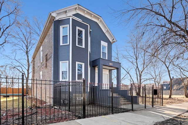 view of front of house with a trampoline and a fenced front yard