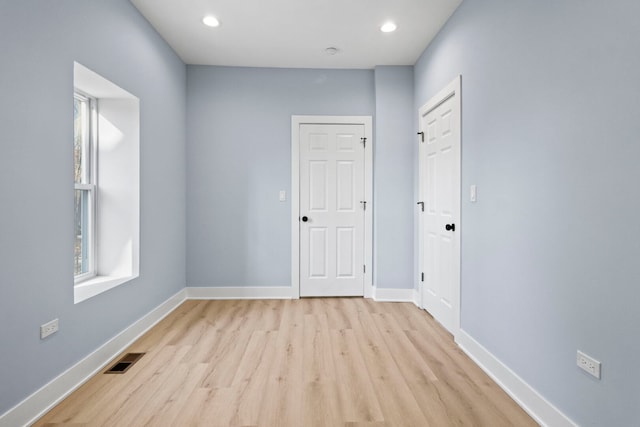 unfurnished room with recessed lighting, visible vents, baseboards, and light wood-style floors