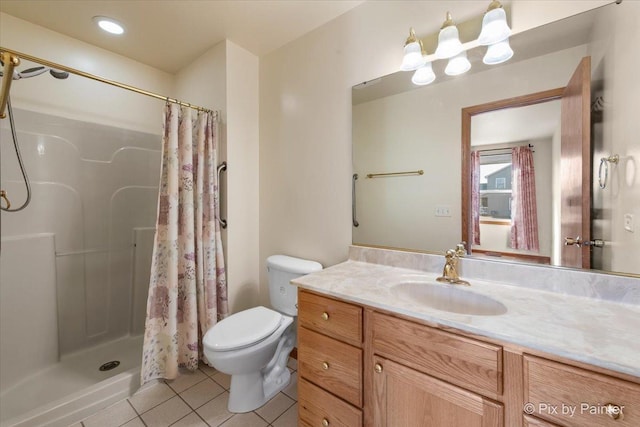 bathroom featuring tile patterned floors, toilet, a stall shower, and vanity