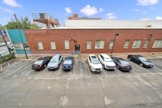 view of building exterior featuring uncovered parking