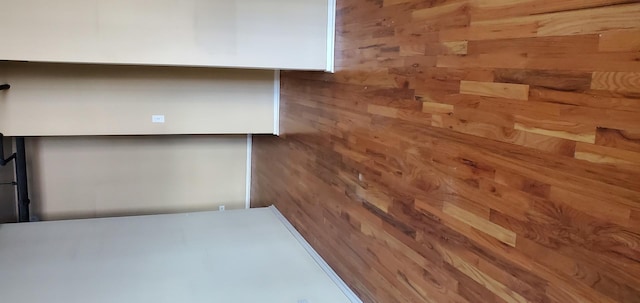 unfurnished room featuring wood walls