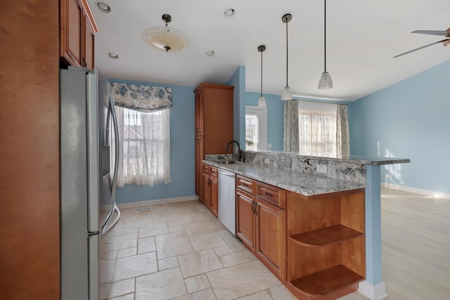 kitchen featuring brown cabinetry, a peninsula, open shelves, a sink, and appliances with stainless steel finishes