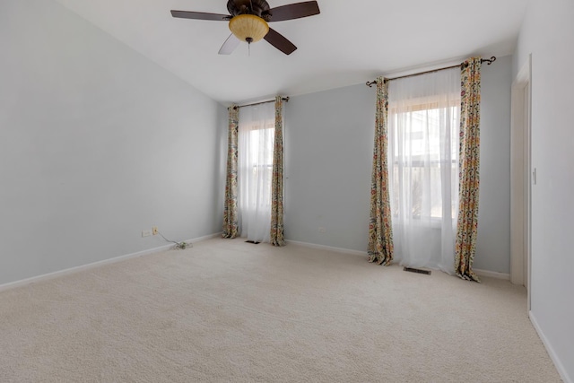 unfurnished room featuring visible vents, baseboards, ceiling fan, and carpet floors