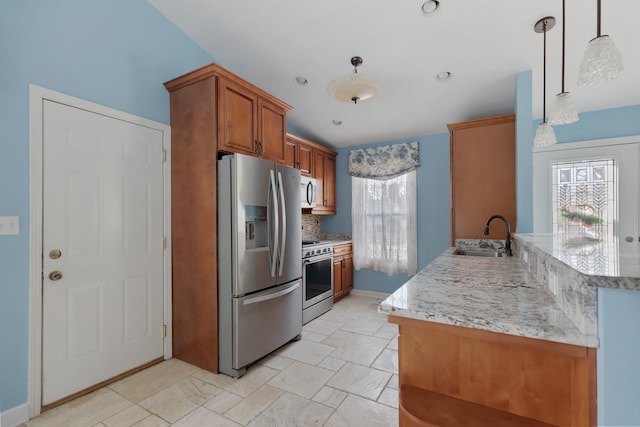 kitchen featuring brown cabinets, a sink, tasteful backsplash, appliances with stainless steel finishes, and a peninsula