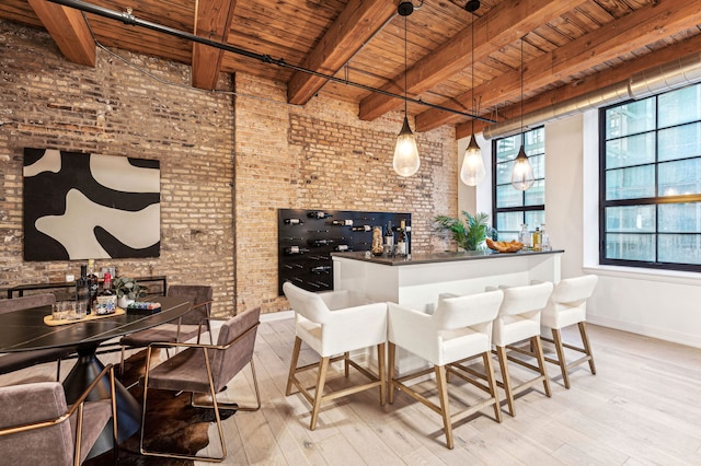 interior space with light wood finished floors, wooden ceiling, and a bar