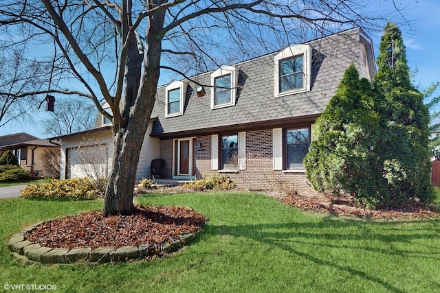 view of front of house with driveway, roof with shingles, a front yard, an attached garage, and brick siding