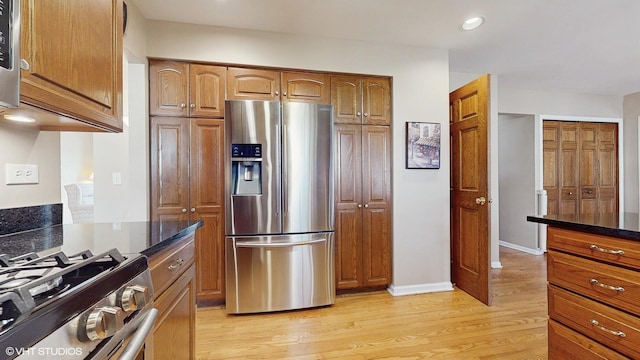 kitchen featuring light wood-style floors, brown cabinets, and appliances with stainless steel finishes