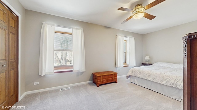 bedroom with a ceiling fan, carpet, visible vents, and baseboards