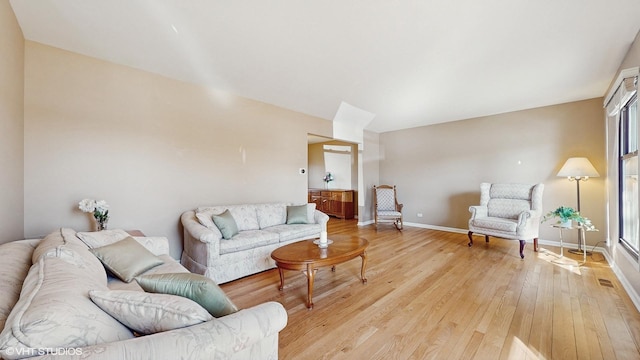 living area featuring light wood-type flooring and baseboards