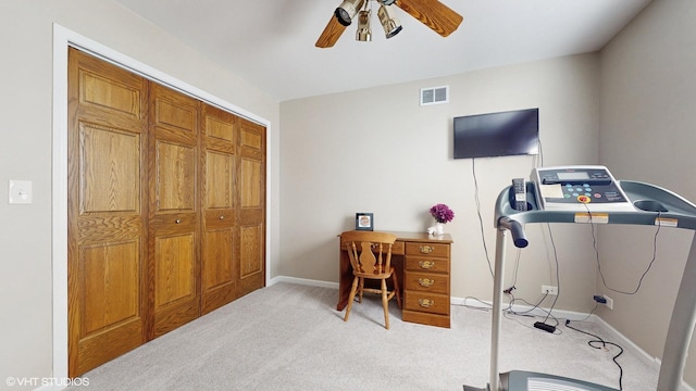 office space with light colored carpet, a ceiling fan, visible vents, and baseboards