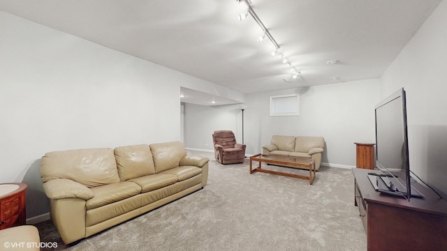 living room with rail lighting, carpet flooring, and baseboards