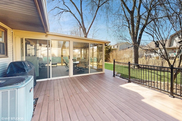 wooden deck with cooling unit and a sunroom