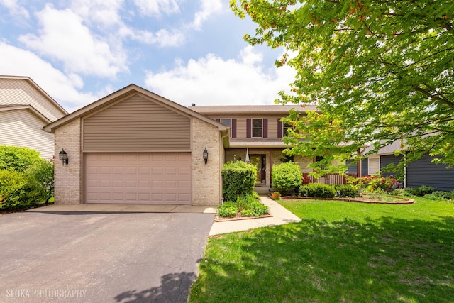 traditional-style house with brick siding, driveway, an attached garage, and a front lawn