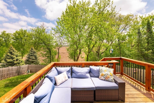 deck featuring outdoor lounge area and fence